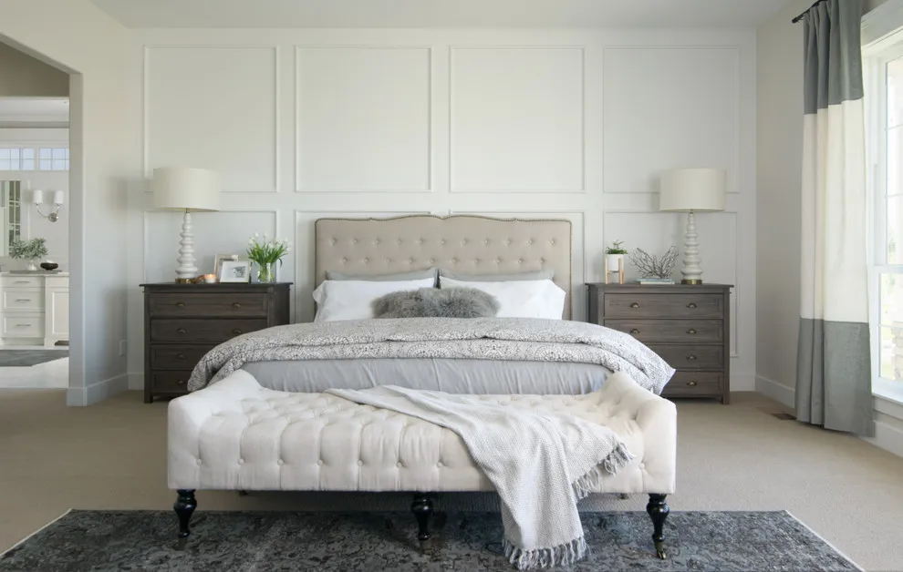 White rectangular panels frame a pale tufted bed and dark nightstands