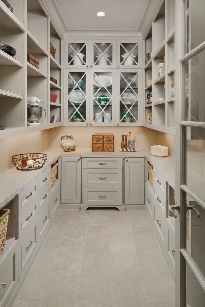 A light pantry contains a taupe lower cabinet beneath a small worktop and open shelving