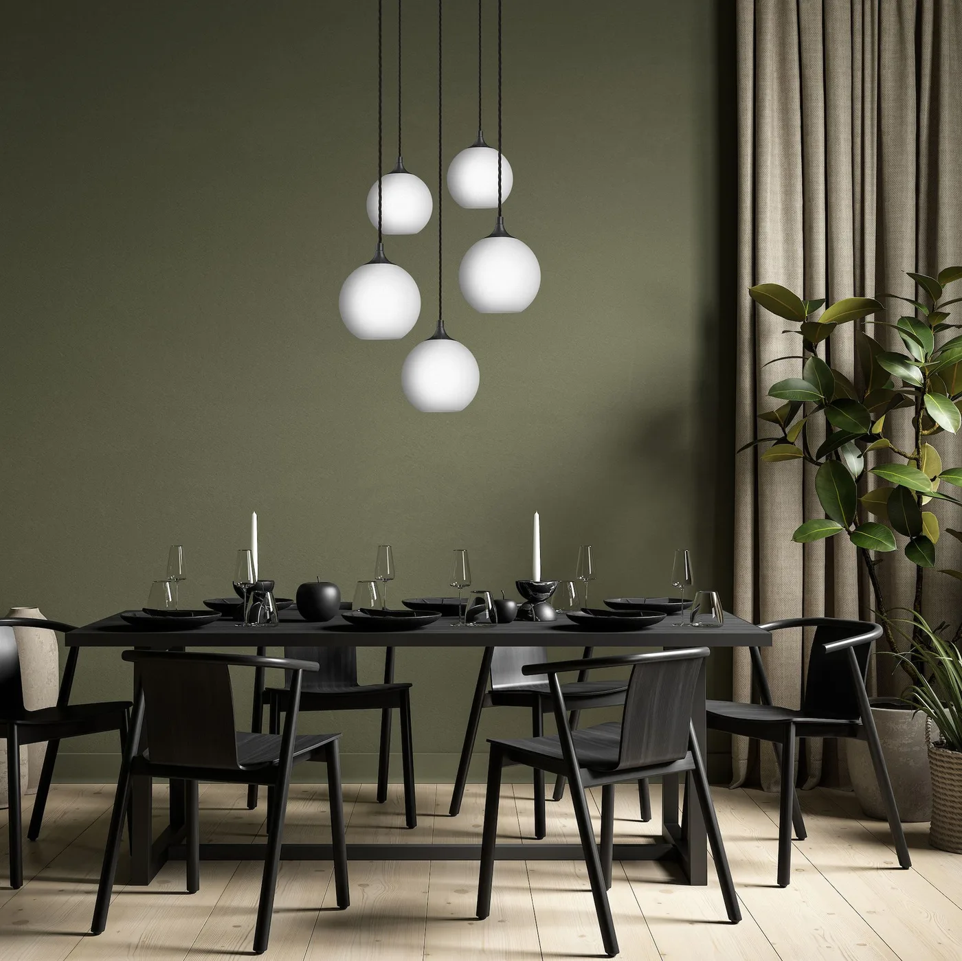 Five white globe lights at staggered heights above a black dining table against olive walls