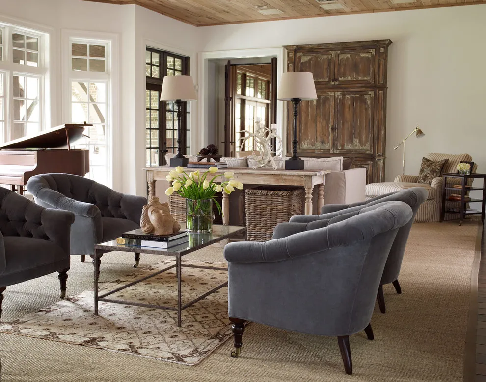 Rounded blue-gray chairs sit around a rectangular table in a room with timber and stone details