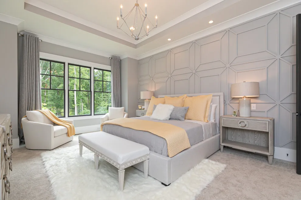 Pale angular panels frame a bed with yellow bedding beside dark window frames