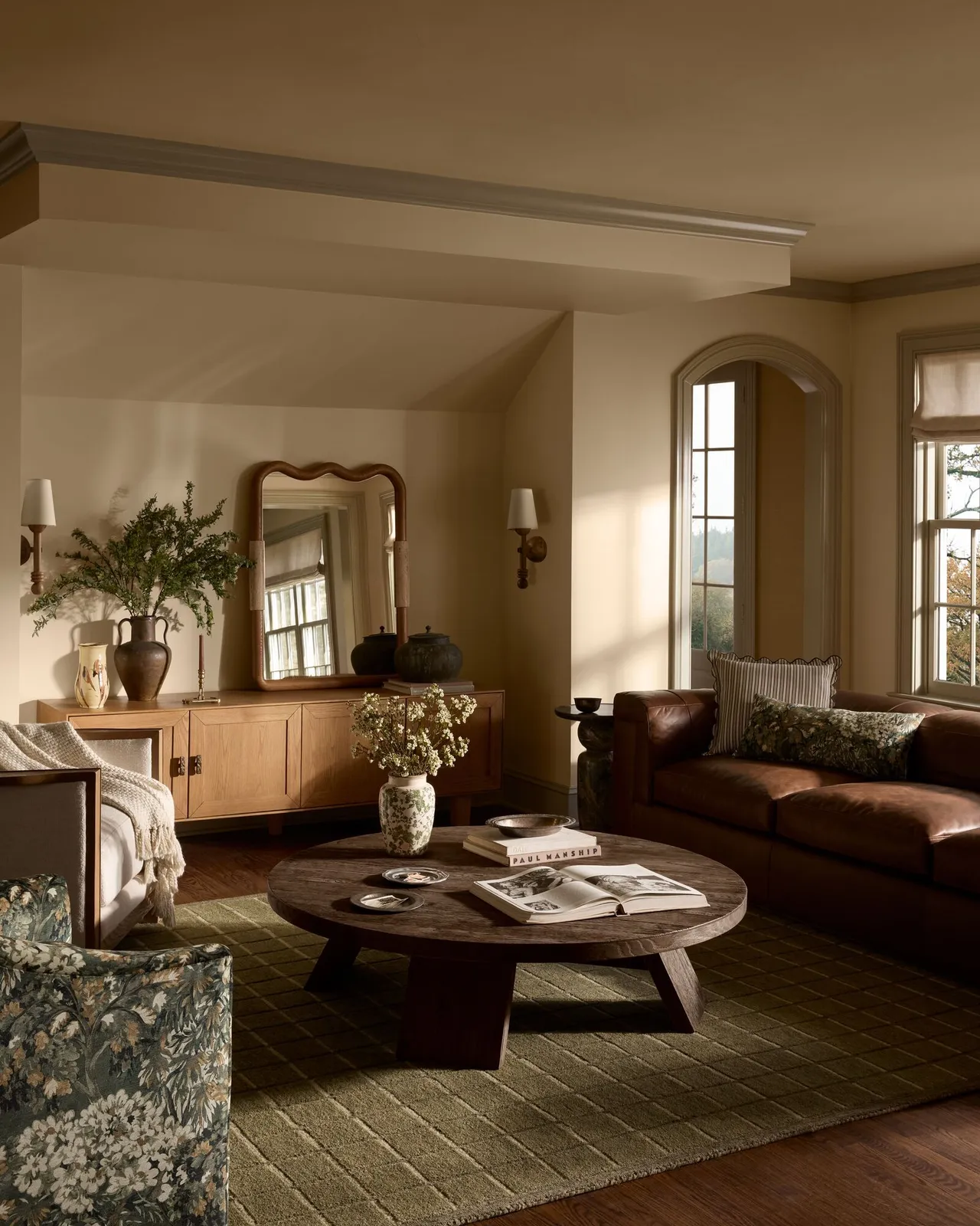 A muted seating group surrounds a low table in softly lit surroundings.