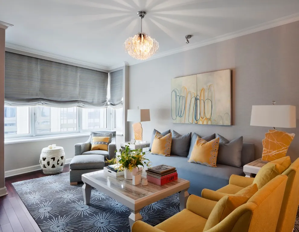 A gray sofa faces mustard chairs across a wooden coffee table