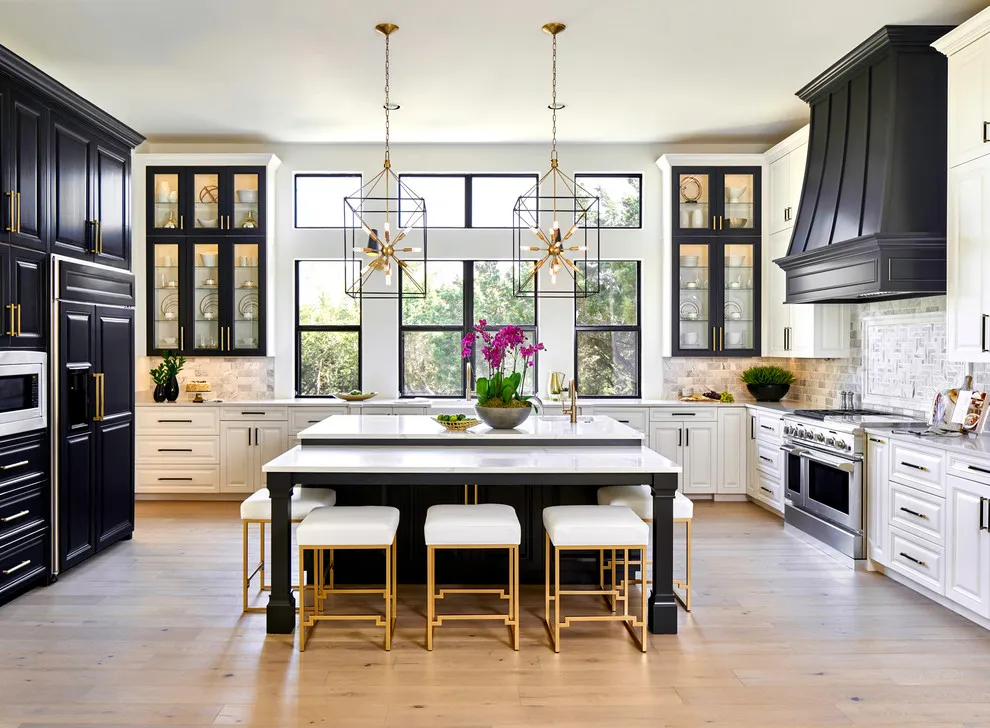 White lower cabinets sit beside dark tall cabinets and a bright window