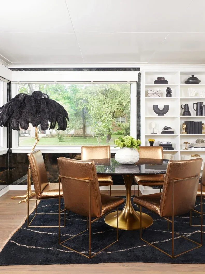 Broad pale treatment above a wide dining window beside white display shelves and brown chairs