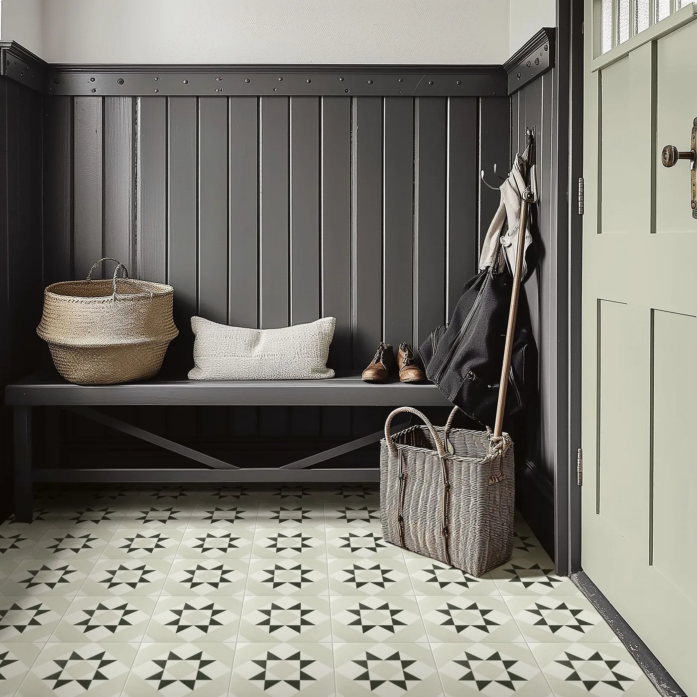 Country entrance with dark vertical paneling, matching narrow bench, pale green door, woven baskets and a pale patterned tile floor.
