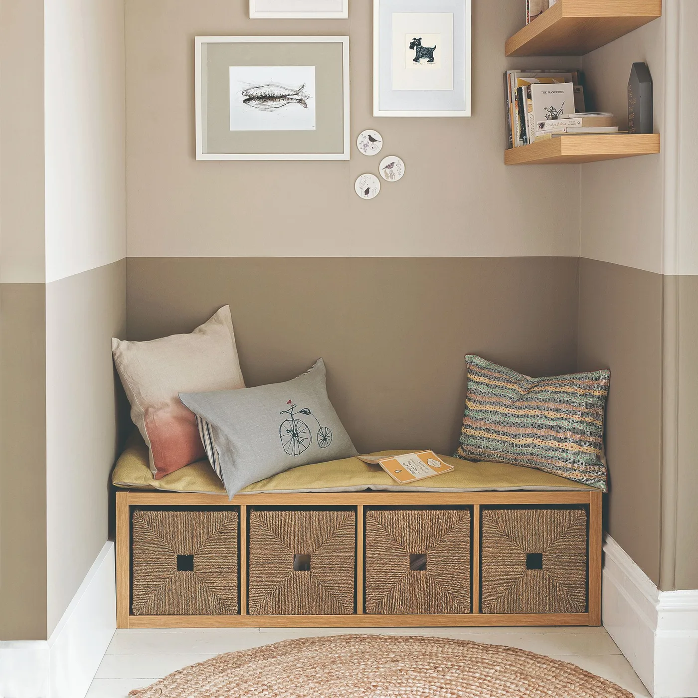Woven drawer fronts sit beneath a taupe two-tone wall with framed animal pictures and small wooden book shelves
