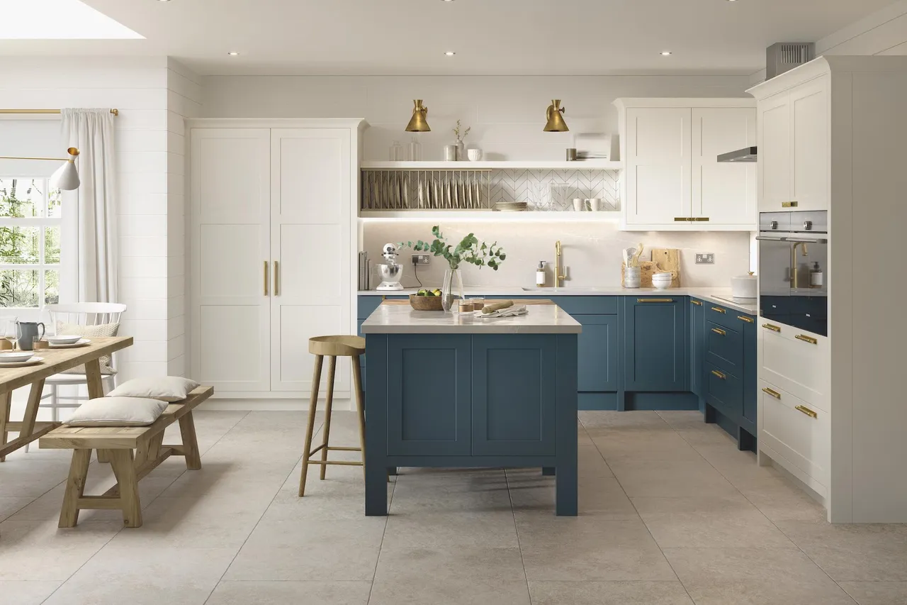 Blue lower cabinets sit beneath white uppers and open shelves in a bright kitchen