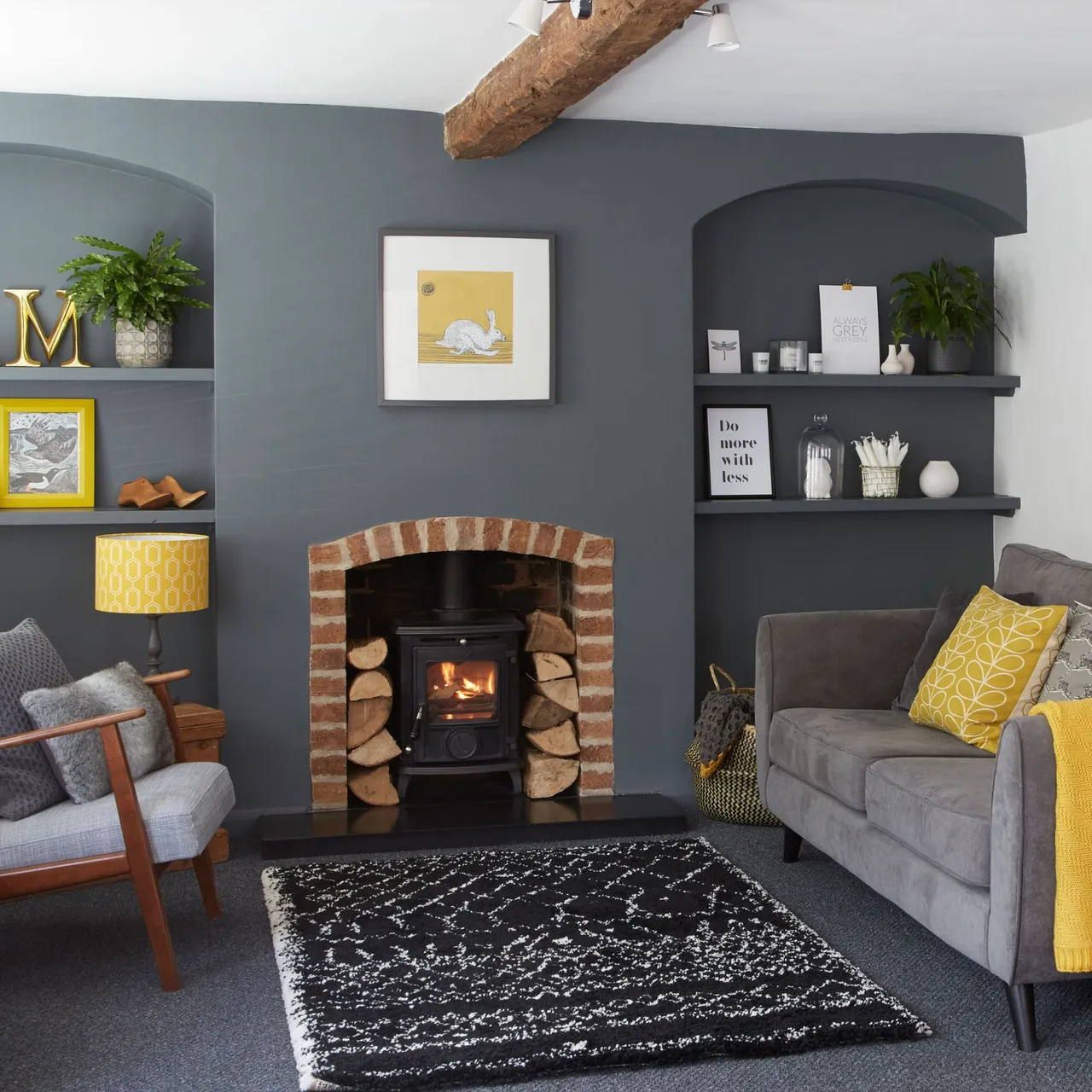 Gray arched alcoves with fitted shelves around brick-edged stove opening and yellow-accented seating