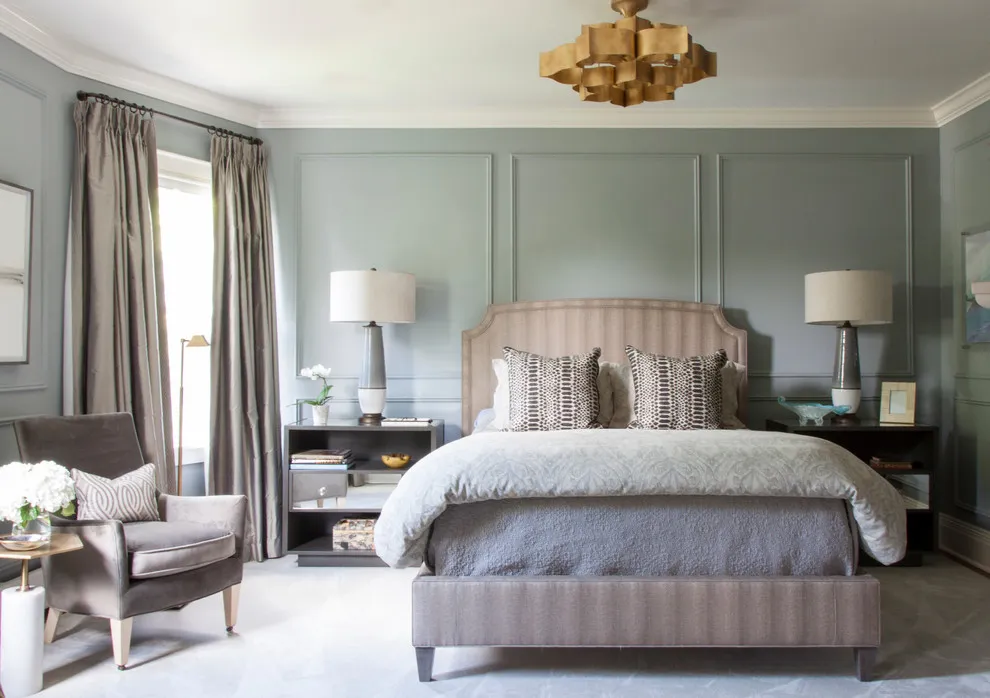 Gray-green rectangular panels frame a timber bed and dark bedside tables