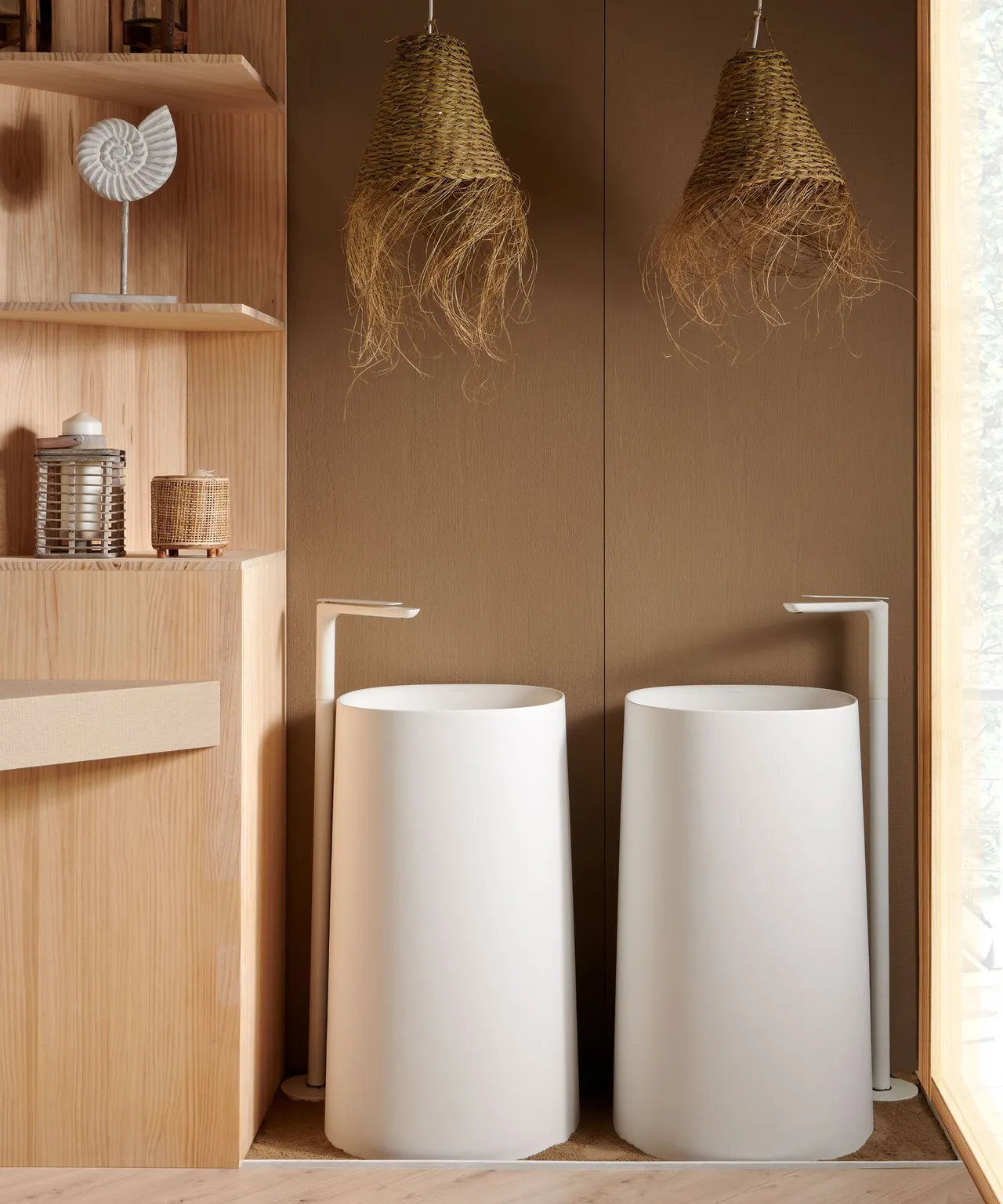 Two pale freestanding basins sit within a warm timber-lined space with open shelving.