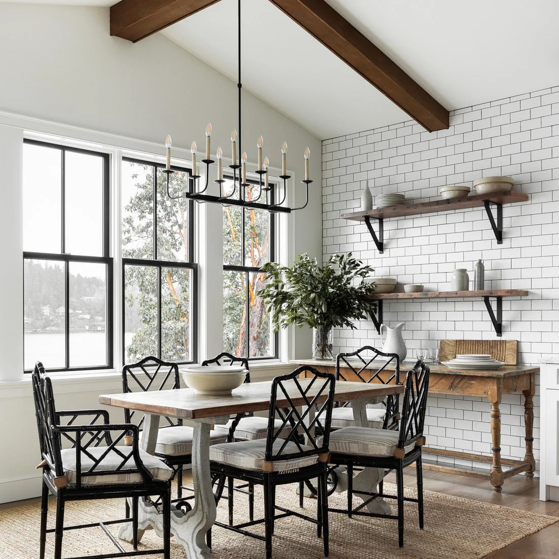 Two bracketed wood shelves holding pale bowls above a dining console against a white tiled wall