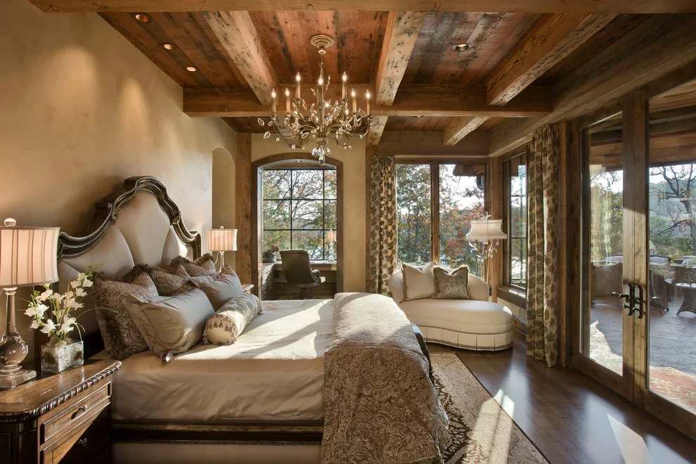 Dark wood flooring sits beneath a traditional bed and substantial timber ceiling beams