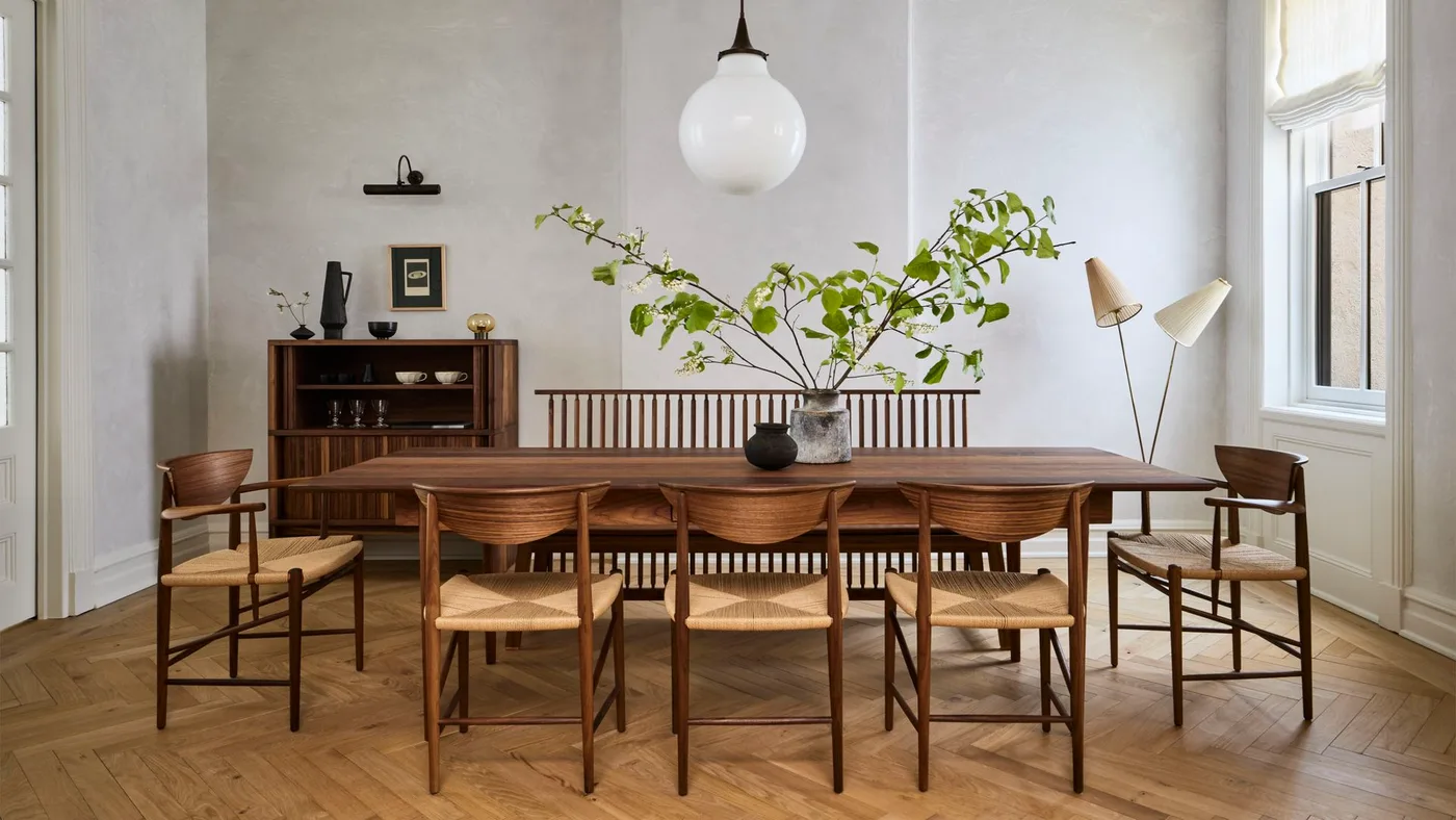 Wood dining table with a globe pendant, a twin-shade floor lamp and a small wall picture light