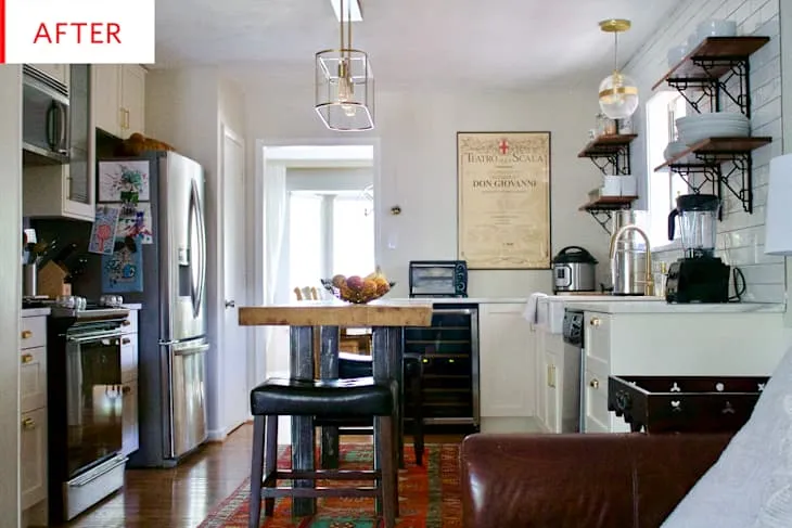 Boho farmhouse kitchen with a wooden island, black leather stools, vintage runner and open shelves