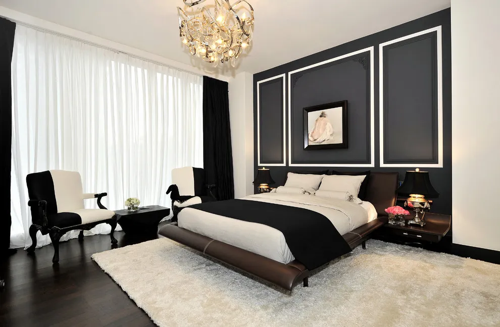Black walls with white rectangular trim sit behind a light bed and pale rug