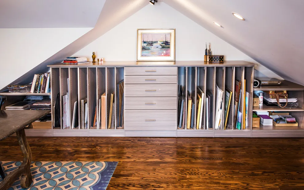 Drawers and open compartments fill the low end of an artist’s attic studio