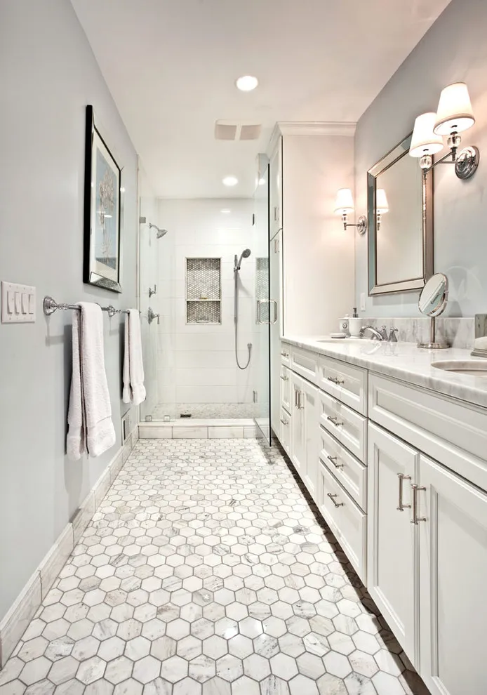 Pale hexagonal tiles cover the floor beside a long white bathroom vanity