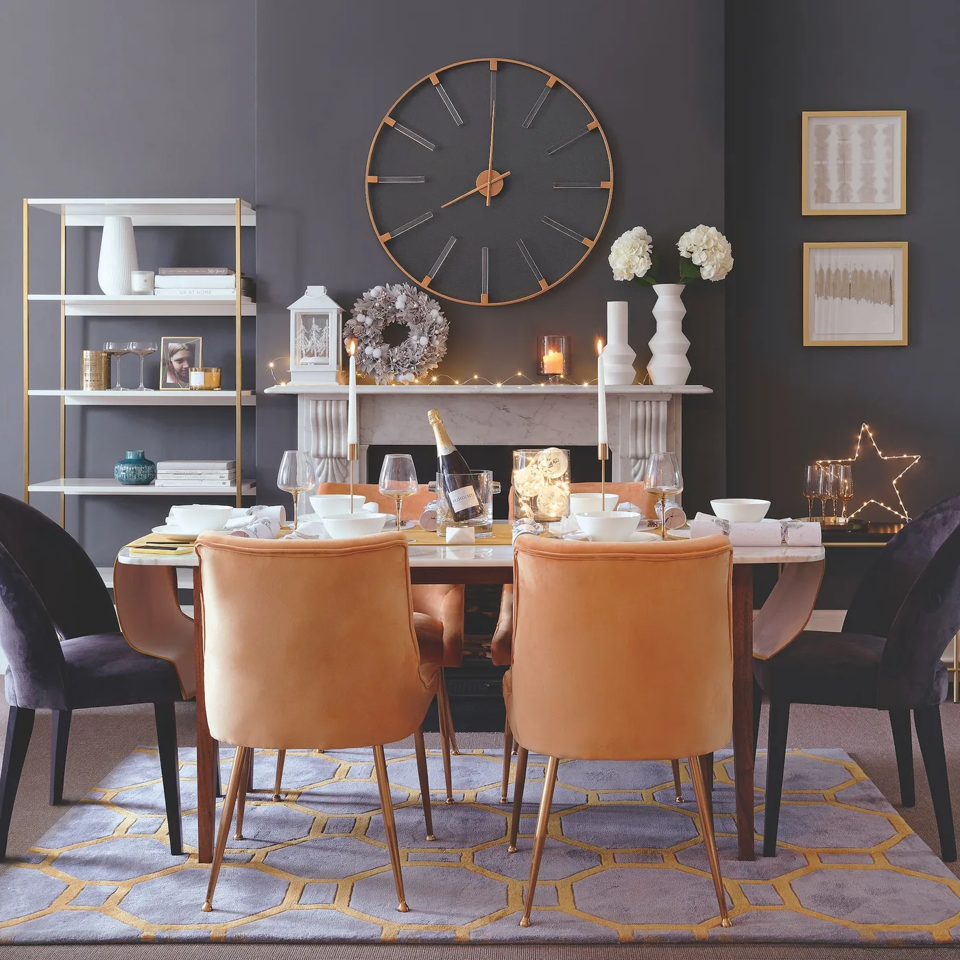Dining room with tan chairs, dark walls, mantel candles and small decorative lights around the table