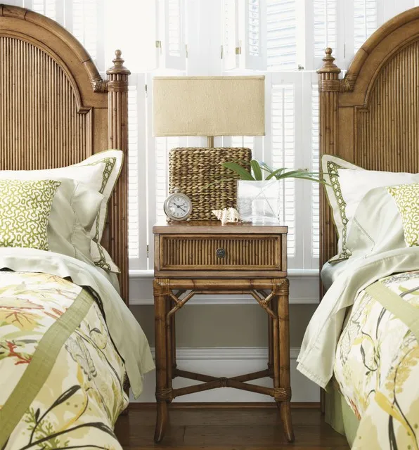 Timber nightstand with a drawer and open crossed base between two matching woven beds